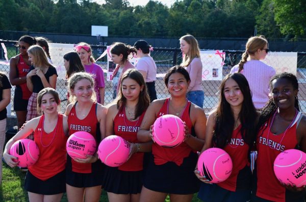 Several class of '25 tennis players pose with their senior day gifts.